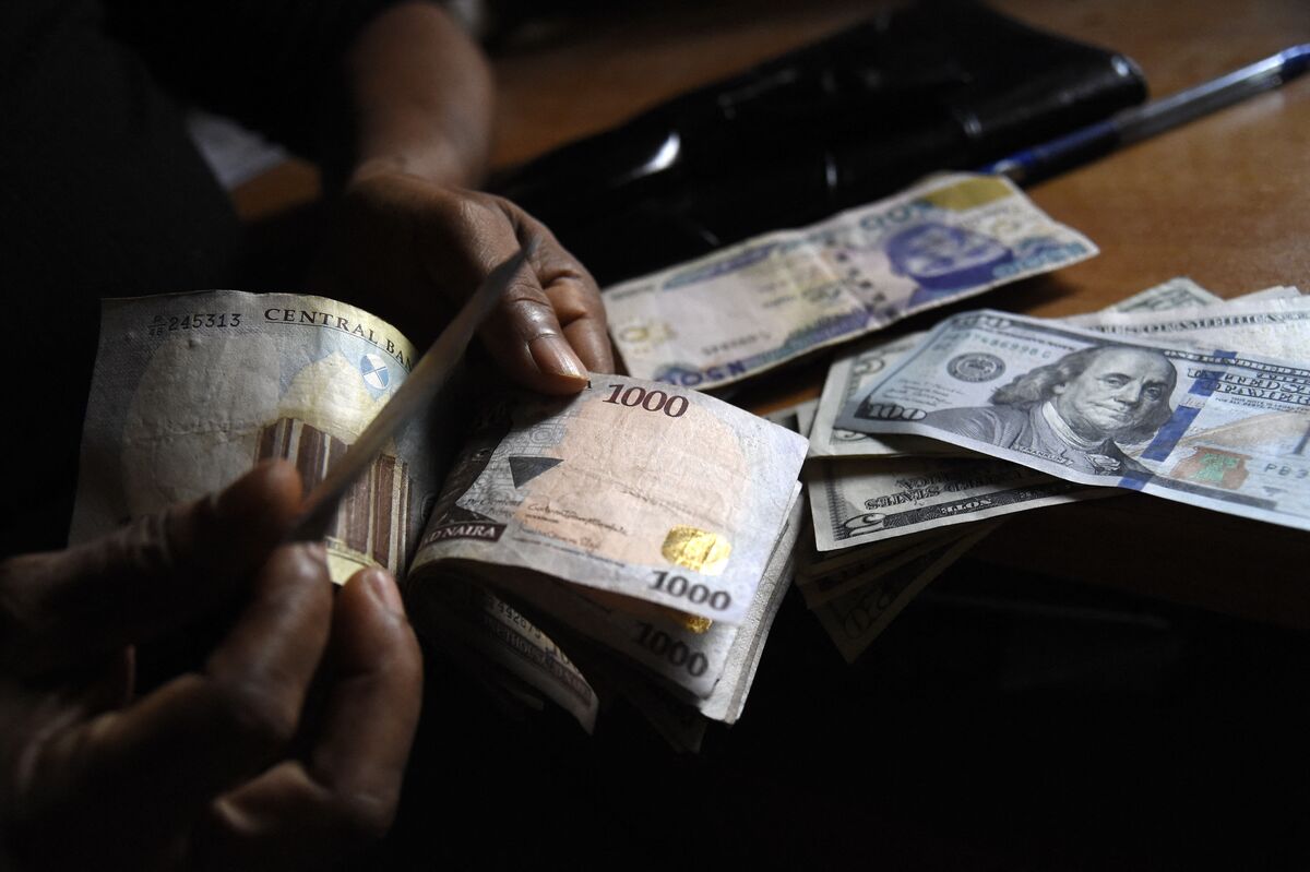 A person exchanges Nigerian Naira for US dollars in Lagos, Nigeria.Photographer: Pius Utomi Ekpei/AFP/Getty Images